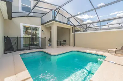 a swimming pool in a house with a glass ceiling at Disney 15min - Private Pool BBQ in Kissimmee