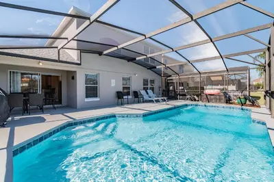an indoor swimming pool with a glass ceiling at Lake Berkley Getaway – 5BR Private Pool in Kissimmee