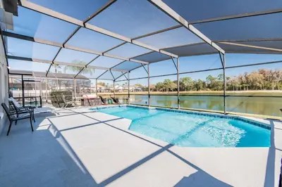 an image of a swimming pool with a roof at Lake Berkley Getaway – 5BR Private Pool in Kissimmee