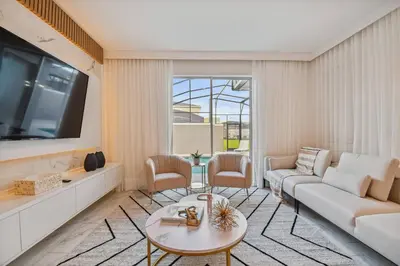 a living room with a couch and a tv at Disney Retreat · Pool Themed Bedrooms in Kissimmee
