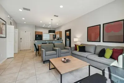 a living room with a couch and a table at Encantada Resort 15min Disney in Kissimmee
