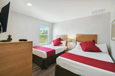 a hotel room with two beds and a window at Encantada Resort 15min Disney in Kissimmee