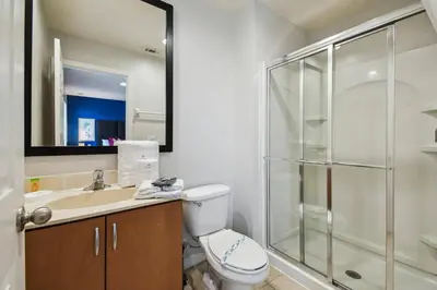a bathroom with a toilet and a sink and a shower at Encantada Resort 15min Disney in Kissimmee