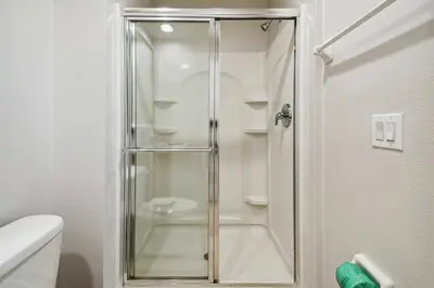 a shower with a glass door in a bathroom at Encantada Resort 15min Disney in Kissimmee