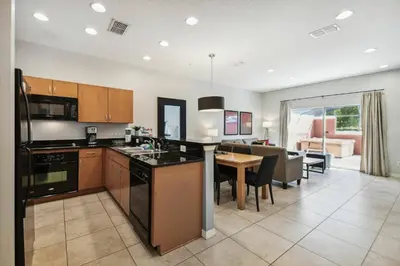 a kitchen and living room with a dining room at Encantada Resort 15min Disney in Kissimmee