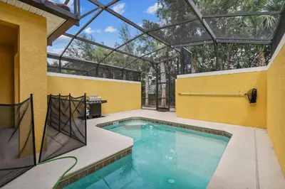 a swimming pool in a building with a glass ceiling at Orlando Getaway w Heated Pool in Kissimmee