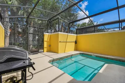 a swimming pool in a glass house with a swimming poolvisor at Orlando Getaway w Heated Pool in Kissimmee