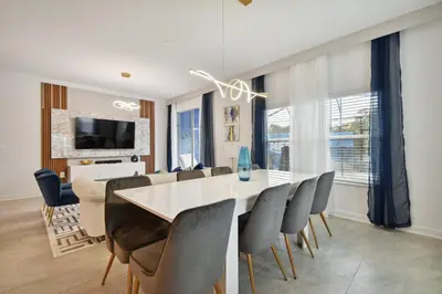 a dining room with a white table and chairs at Family Retreat near Disney in Kissimmee