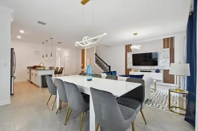 a dining room and living room with a table and chairs at Family Retreat near Disney in Kissimmee