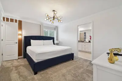 a bedroom with a bed and a chandelier at Family Retreat near Disney in Kissimmee