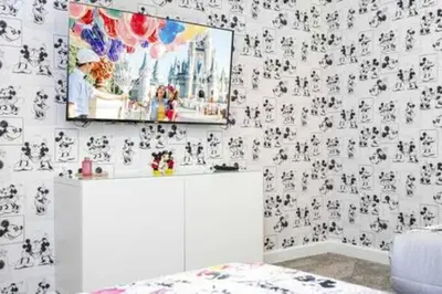 a room with a wall covered in black and white wallpaper at Family Retreat near Disney in Kissimmee