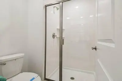 a bathroom with a glass shower with a toilet at Family Retreat near Disney in Kissimmee