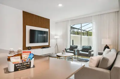 a living room with a couch and a tv at 4BR Townhome Near Disney Water Park in Kissimmee