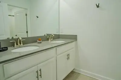 a bathroom with two sinks and a large mirror at Orlando Retreat – 4BR Home Near Disney in Kissimmee