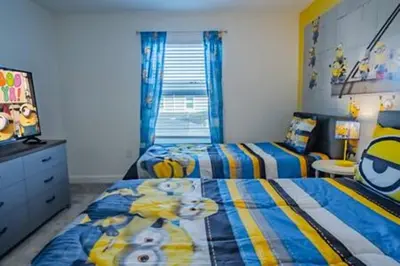 a childs bedroom with two beds and a television at Orlando Retreat – 4BR Home Near Disney in Kissimmee
