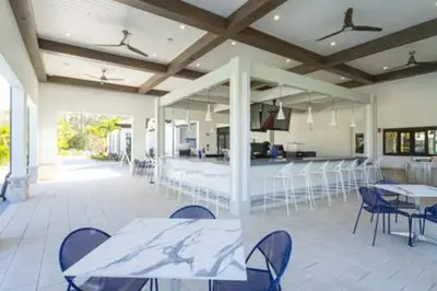 a room with tables and chairs and a kitchen at Orlando Retreat – 4BR Home Near Disney in Kissimmee
