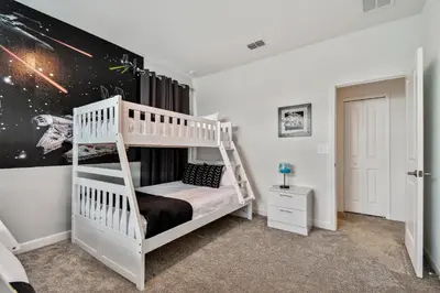 a bedroom with a white bunk bed in a room at Spacious Orlando Stay near Disney in Kissimmee