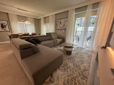 a living room with a couch and a table at Orlando Luxury Stay Near Disney Parks in Kissimmee