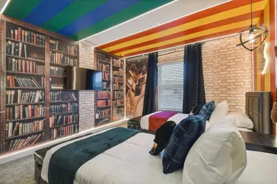 two beds in a room with a rainbow ceiling at Orlando Getaway – Minutes to Disney Parks in Kissimmee