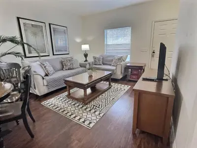 a living room with a couch and a table at Family Getaway Near Disney Parks in Kissimmee