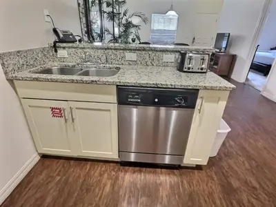 a kitchen with a sink and a dishwasher at Family Getaway Near Disney Parks in Kissimmee