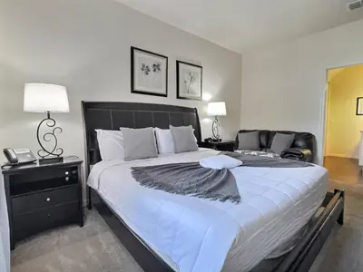 a bedroom with a large bed with a black headboard at Family Getaway Near Disney Parks in Kissimmee