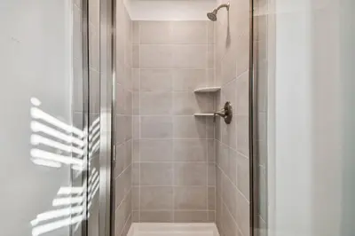 a bathroom with a shower with a glass door at Disney Getaway: Private Pool Resort in Kissimmee