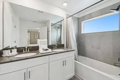 a bathroom with two sinks and a large mirror at Private Pool Luxury Resort Amenities in Kissimmee