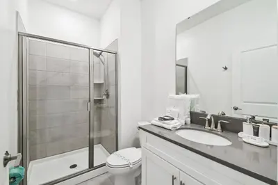 a bathroom with a toilet and a sink and a shower at Private Pool Luxury Resort Amenities in Kissimmee