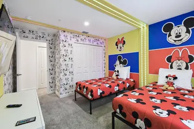 two beds in a room with a mickey bedroom at Private Pool Luxury Resort Amenities in Kissimmee