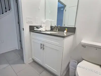 a white bathroom with a sink and a toilet at Luxury Home Near Disney Orlando in Kissimmee