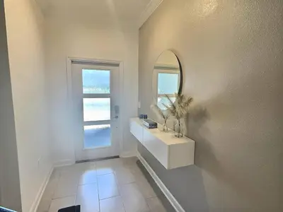 a white bathroom with a sink and a mirror at Luxury Home Near Disney Orlando in Kissimmee