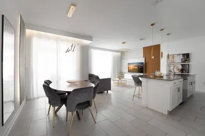 a kitchen and dining room with a table and chairs at Luxury Family Stay Near Disney in Kissimmee