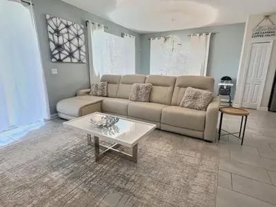 a living room with a couch and a coffee table at Heated Pool 5-Star Amenities Near Disney in Kissimmee