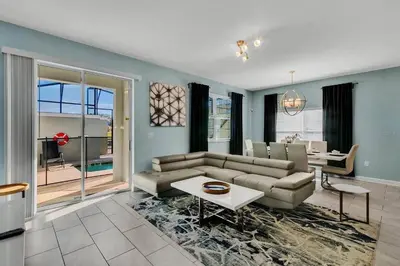 a living room with a couch and a table at Heated Pool 5-Star Amenities Near Disney in Kissimmee