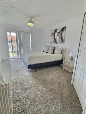 a bedroom with a bed and a large window at Family Villa near Disney – 15 Min in Kissimmee