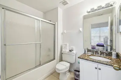 a bathroom with a shower and a toilet and a sink at 4BR Home Game Room in Lake Berkley in Kissimmee