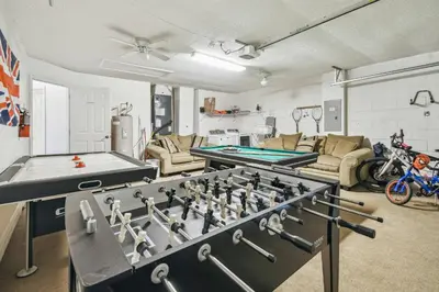 a living room with two ping pong tables at 4BR Home Game Room in Lake Berkley in Kissimmee