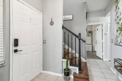 a hallway with a white door and a staircase at Resort Townhome · Sleeps 8 · Pool in Kissimmee