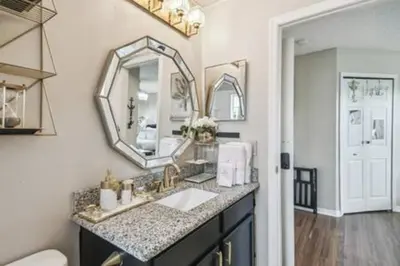 a bathroom with a sink and a mirror at Resort Townhome · Sleeps 8 · Pool in Kissimmee