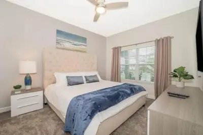 a bedroom with a large bed and a window at Family Villa · Near Disney · Sleeps 10 in Kissimmee