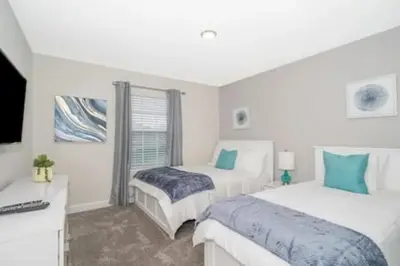 a bedroom with two beds and a desk with a computer at Family Villa · Near Disney · Sleeps 10 in Kissimmee