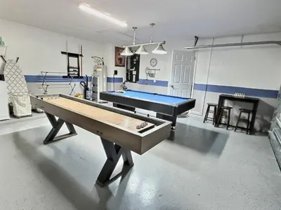 a ping pong table in a room with a pool table at Lake Berkley · Family Home Near Disney in Kissimmee