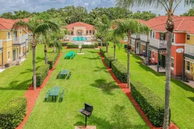 an aerial view of a park with palm trees and benches at Lake Berkley · Family Home Near Disney in Kissimmee
