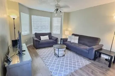a living room with two couches and a tv at Montego Bay Retreat w Pool in Kissimmee