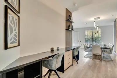 a kitchen with a long counter with chairs and a table at Vista Cay Getaway · Orlando Stay in Orlando