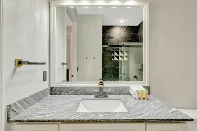 a bathroom with a sink and a mirror at Vista Cay Getaway · Orlando Stay in Orlando