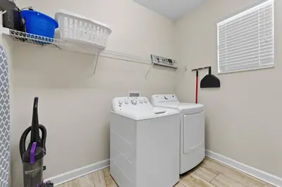 a laundry room with a washer and dryer at Spacious 6BR Pool Resort - Near Disney in Kissimmee