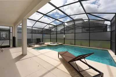 an indoor swimming pool with a glass ceiling at Spacious 6BR Pool Resort - Near Disney in Kissimmee