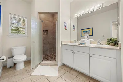 a bathroom with a shower and a toilet and a sink at Orlando Family Stay · Pool Clubhouse in Kissimmee